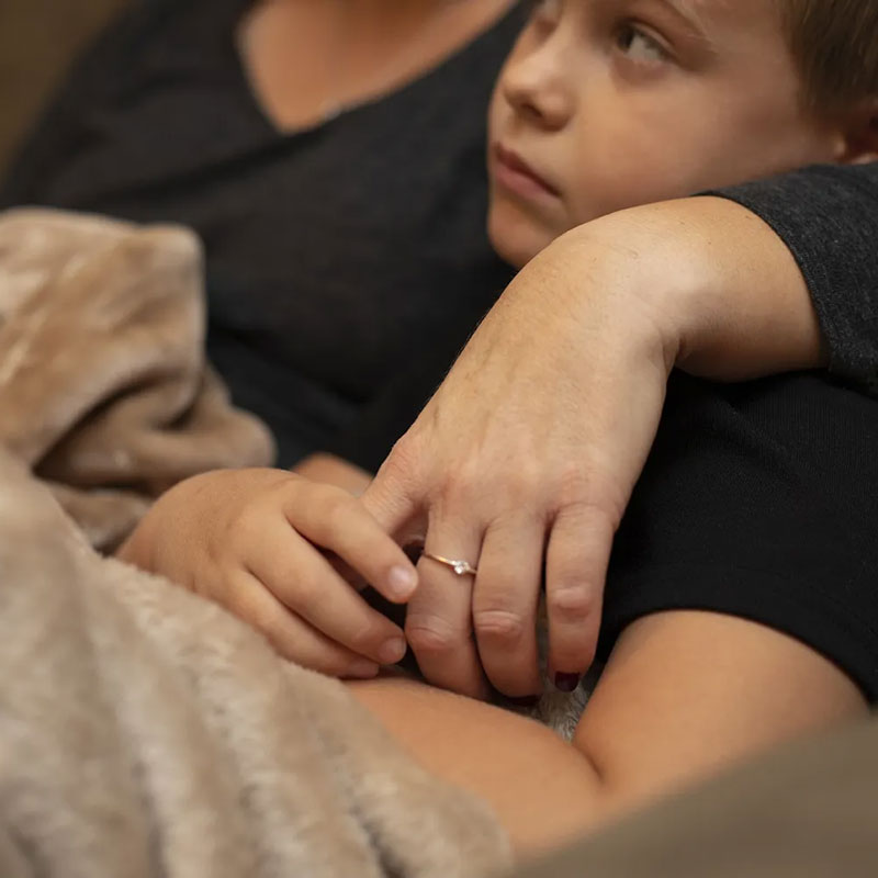 kid and mom sitting with blanket